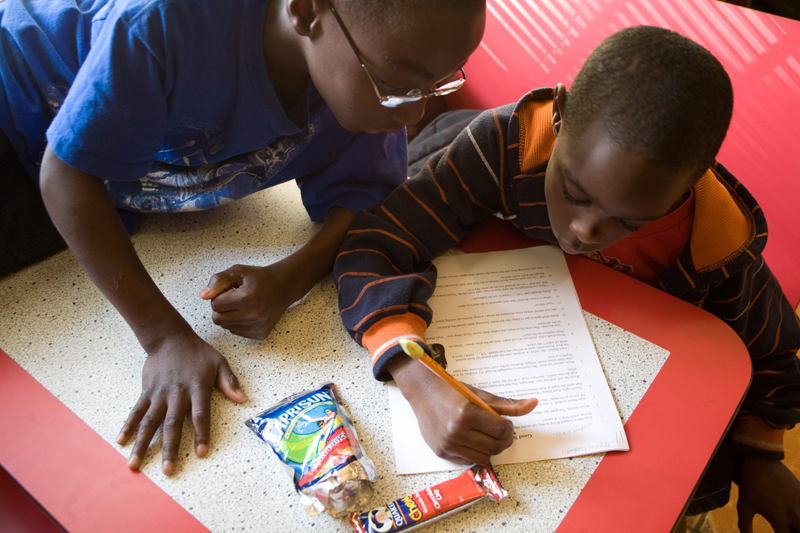 At Mission Possible, kids help other kids. Tyquel (left) helped Keman with English homework.