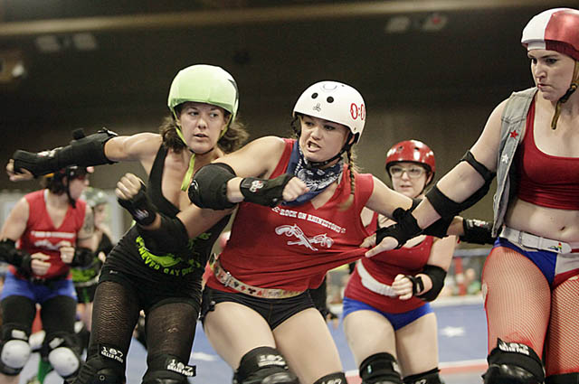 Lani “Scrappy” Ogle of the Cherry Bombs tries to fight past Nicki "Ticki Timebomb" Prifogle during the Texas Roller Derby Lonestar Rollergirls Championship. Photo by Oscar Ricardo Silva