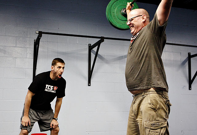 CrossFit Renew director Chris Allman coaches Matthew Harris at a CrossFit center located in the St. Johns area of north east Austin. Photo by Shweta Gulati