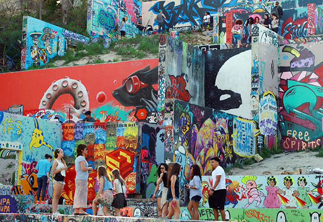 Visitors to Austin's Graffiti Park make their way up and down the vibrant display. Photo by Silvana Di Ravenna
