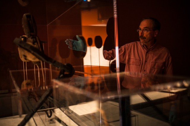 James Bruseth, guest curator at the Bullock Texas State History Museum, with tools recovered from the La Belle, which sank in the Gulf of Mexico in the 17th century. Photo by Lukas Keapproth/Reporting Texas