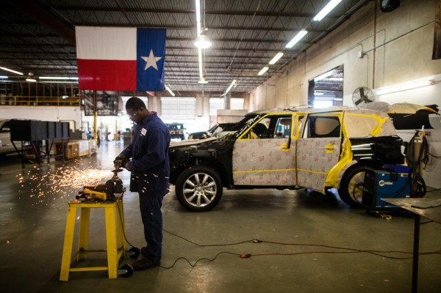 Dominic Mitchell grinds custom-made parts to outfit a Toyota SUV at the Texas Armoring Corporation in San Antonio, Texas, on October 17, 2014. Photo by Lukas Keapproth/Reporting Texas.