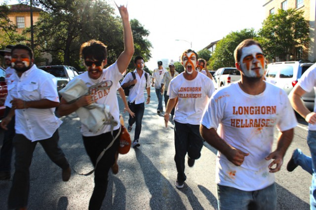 Members of the UT spirit group, The Longhorn Hellraisers, stampede toward the stadium to watch the Texas v. BYU football game on Sept. 6, 2014. Photo by Andie Rogers/Reporting Texas