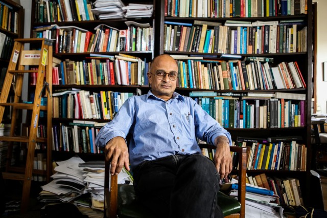 Dr. Sarkar in front of a towering bookcase in UT Austin's Waggener Hall on Oct. 2, 2014. Photo by Megan Dolan/Reporting Texas