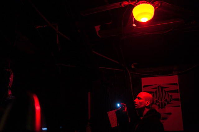 Charles Erlandson shines a flashlight into a crawl space during a paranormal investigation at a downtown nightclub in Austin, Texas, on December 1, 2014. Lukas Keapproth/Reporting Texas