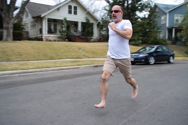 Andrew Palmore, a barefoot running enthusiast, out for a run in the Hyde Park neighborhood of Austin on Sunday, March 8, 2015. The barefoot running movement, also known as minimalist jogging, has its origins in the Tarahumara people of northwest Mexico and has become so popular that Palmore and others have begun running half-marathons without shoes. Photo by Olivia Starich/Reporting Texas