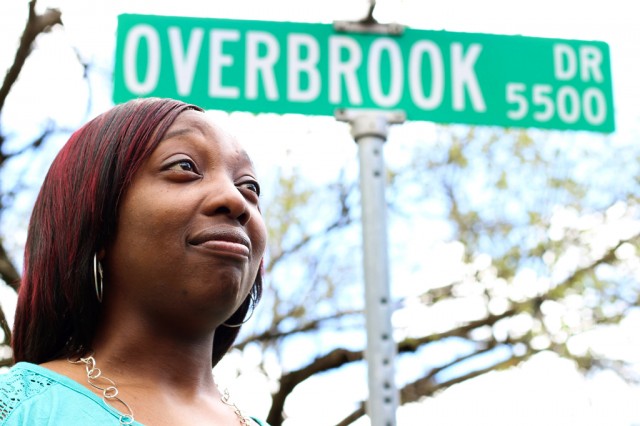 Carlotta Hamilton stands at the corner of the street where she grew up on Sunday, March 22, 2015. As a twelve-year-old on her way home from school, Hamilton was verbally accosted here by two black men due to the length of her hair. Photo by Hilary Pearson/Reporting Texas
