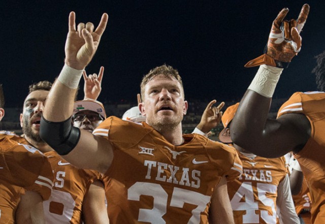 Nate Boyer proudly puts his horns up after the Longhorns win over Oklahoma State. Photo by Joe Capraro/Special Contributor 