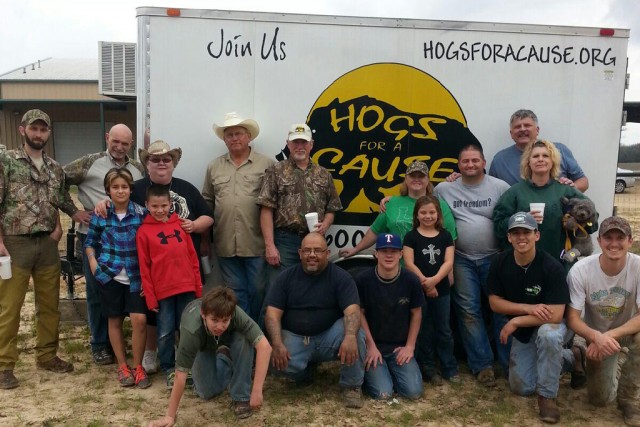 Hunters with Hogs for a Cause stand in front of the organization's refrigerated hog meat transport trailer. Photo Courtesy of Hunters for Hogs.