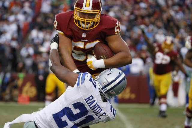 Dallas Cowboys running back Joseph Randle (21) tackles Washington Redskins defensive end Jackson Jeffcoat (53) after Jeffcoat caught an interception from quarterback Tony Romo (9) in the fourth quarter during the National Football League regular season finale game between the Dallas Cowboys and Washington Redskins at FedEx Field in Landover, Maryland Sunday December 28, 2014. Photo by Andy Jacobsohn/The Dallas Morning News