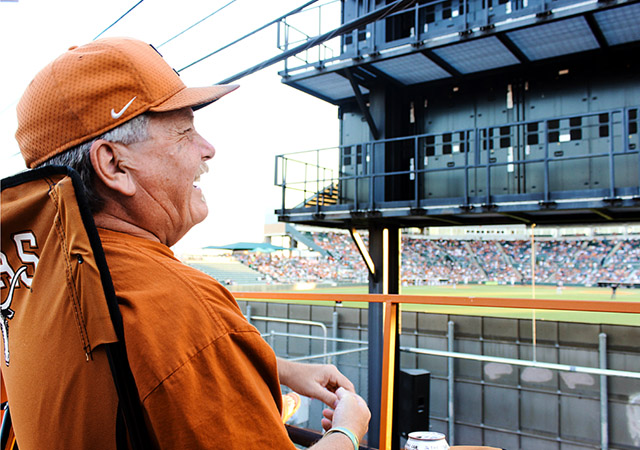 Randy Jackson, co-owner and original member, laughs from his perch on top high atop the House of Horns fan bus, parked just beyond the outfield wall of Disch-Falk Field. It’s the last home series of the season for the Longhorn Baseball team and the House of Horns reminisce about games long since passed. Photo by Hilary Pearson