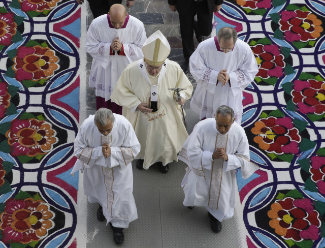 Pope Francis enters, clutching his pastoral staff, the Basilica of the Virgin of Guadalupe in Mexico City, Saturday, Feb. 13, 2016. Francis will celebrate Mass at the Basilica, considered the largest and most important Marian shrine in the world. (AP Photo/Gregorio Borgia)