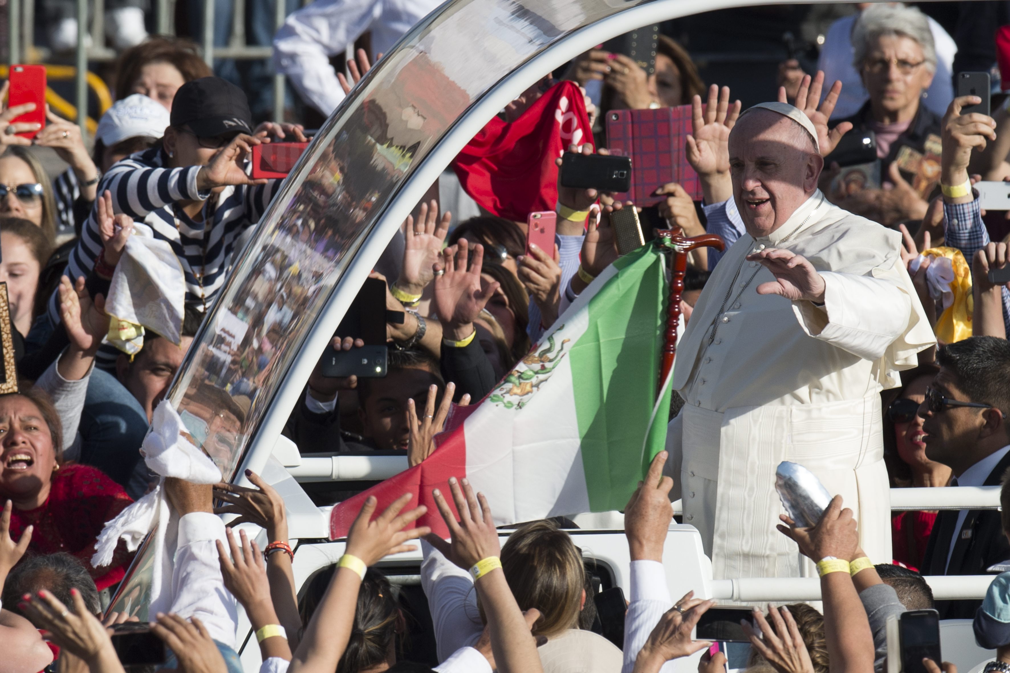In this photo taken on Saturday, Feb. 13, 2016, Pope Francis waves to people as he arrives to the Basilica of the Virgin of Guadalupe in Mexico City, Saturday, Feb. 13, 2016. Francis will celebrate Mass at the Basilica, considered the largest and most important Marian shrine in the world. (L'Osservatore Romano/Pool Photo via AP)