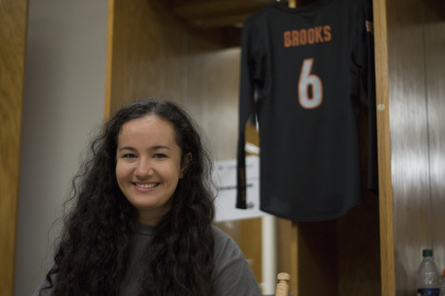 Kat Brooks sits in front of her cubby in the volleyball locker room just as she would before each home game. "I still like to come in here sometimes," Brooks confessed, hanging up her uniform for display. Taylor Weese/Reporting Texas