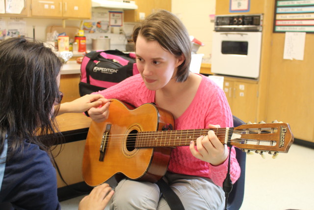 Music therapist Rebecca Faulkner sings and plays guitar for an autistic student at McNeil High School. Faulkner treats special needs students in the Austin area to help them develop a range of interpersonal communication skills. Wes Scarborough/Reporting Texas