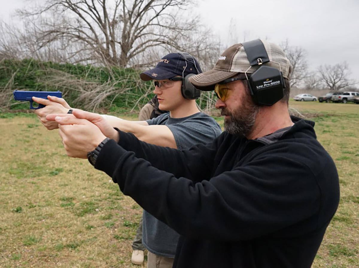 Instructor Brazos Keller (left) demonstrates proper and improper grip techniques to James Eastwood at the UpTex Shooting Range in Upton, Texas. Jack Vrtis/Reporting Texas