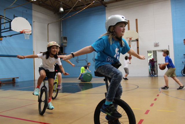 St. Andrew's lower school students take a ride around the gym during their weekly after school unicycling club on May 6, 2016 in Austin,TX. Their club, the Uni-saders, was founded by Jimmy Agnew, who went on to start a nonprofit, One Wheel Many Children, to bring unicyling to children in other Austin communities. Anna Casey/Reporting Texas
