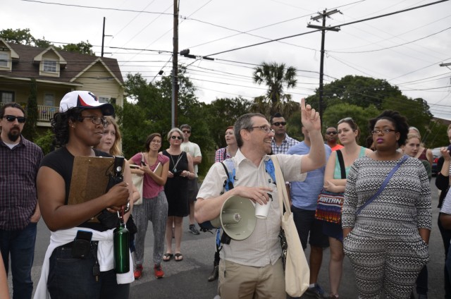 Tour Guides Tara Dudley (Black T-shirt and cap) and Eliot Tretter (middle) with the crowd touring East Austin. Swathi Narayanan/Reporting Texas