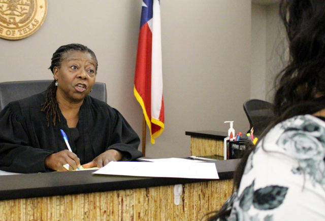 Yvonne Williams, Justice of the Peace for Ward 1 in Travis County, speaks with a student.  Josefina Mancilla / Texas Report