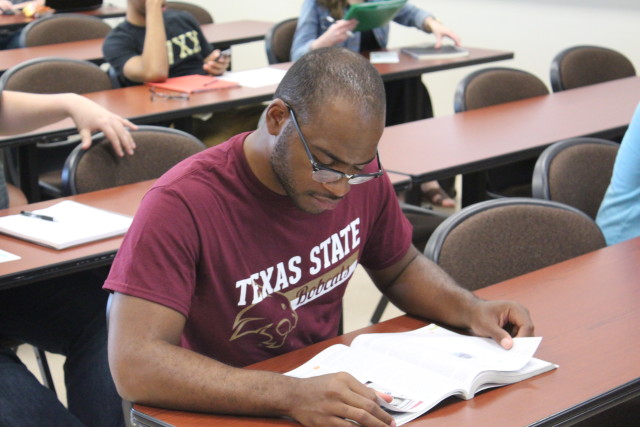 Eric Martin, a mass communications major reads his textbook for his Mass Media and Society class in the Avery building at the Round Rock campus of Texas State University on Monday, April 11, 2016. Austin Hamby/Reporting Texas