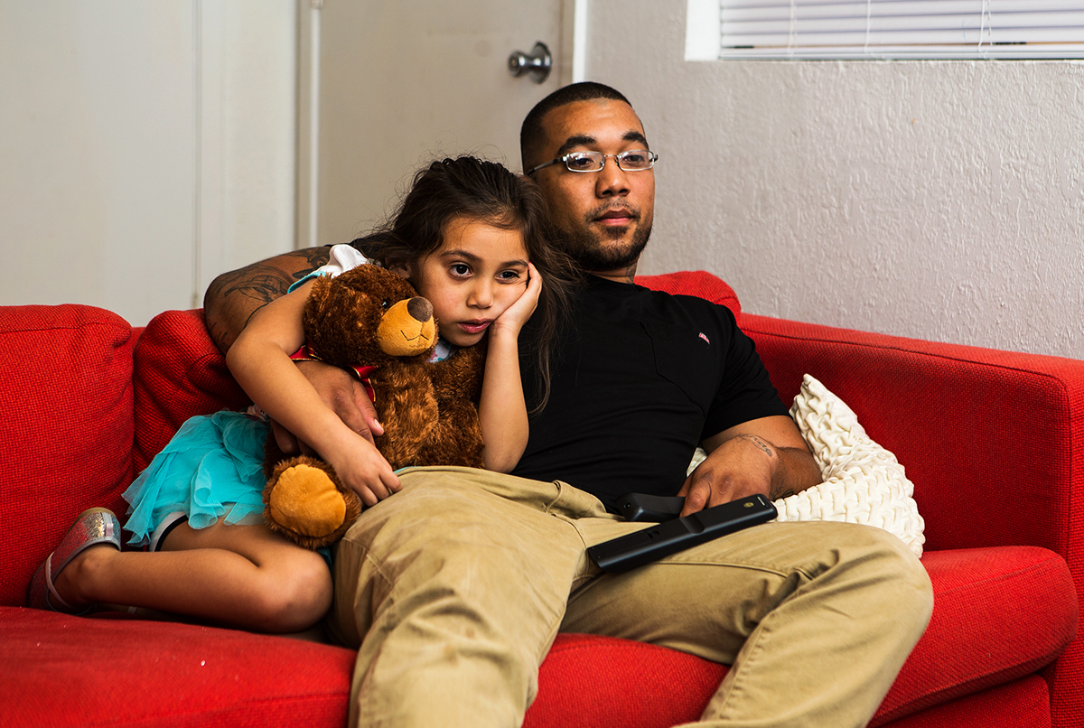 Michael Bowers and his daughter, Hazel, share an apartment in North Austin, Texas on October 7, 2016. Bowers - a single father - was able to move into the apartment in June after having trouble finding housing due to landlords' ability to do criminal background checks online. Bowers works two jobs to support his daughter. They often watch cartoons before Bowers has to go to his second job.