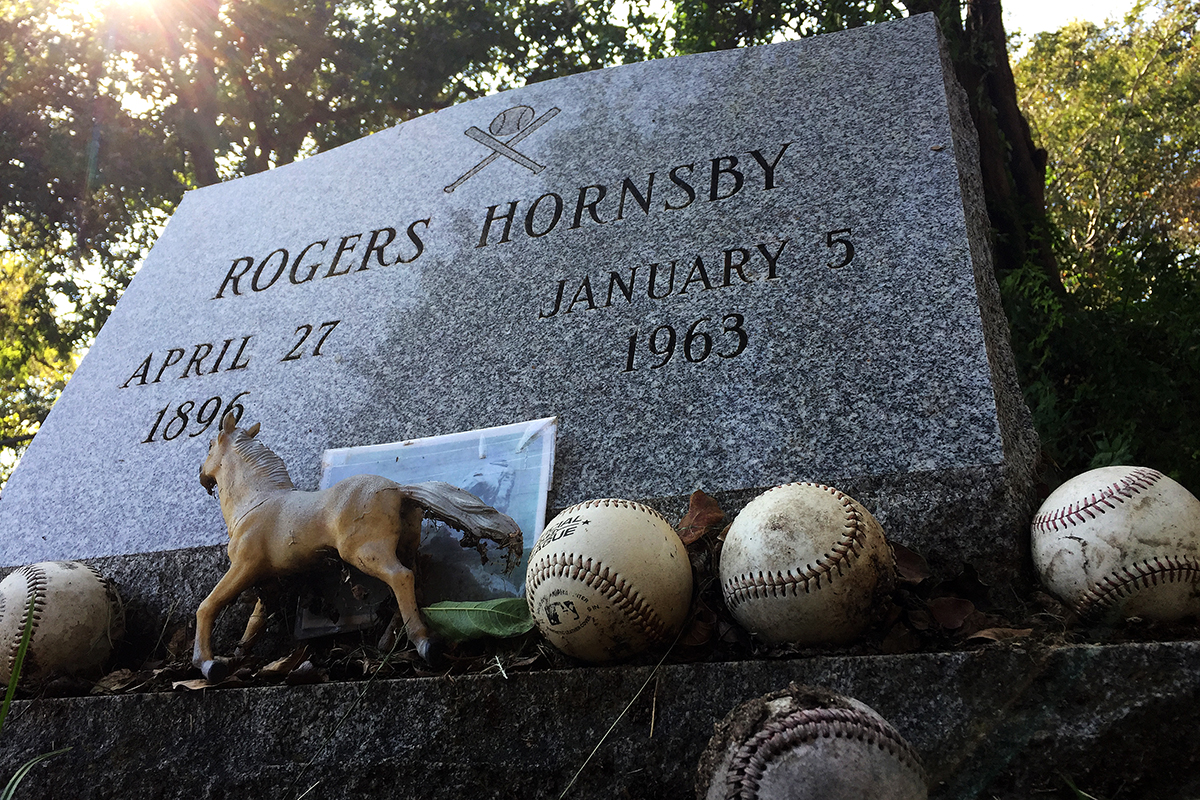 Hornsby's headstone serves as a pilgrimage for diehard baseball fans. Among the gifts fans have left behind are baseballs, a small plastic horse and a laminated photo of Hornsby tagging out Babe Ruth to end the 1926 World Series. Aaron Schnautz/Reporting Texas