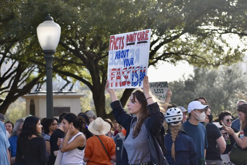 Protesters hoisting signs at the "Stand Up for Science" rally