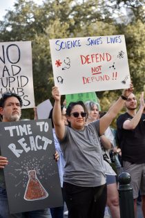 Protesters hold signs in support of science at Capitol rally