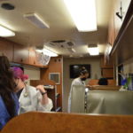 We Are Blood staff Inside the bloodmobile preparing to draw blood from doors. (Photo: Maggy Wolanske, Reporting Texas TV)